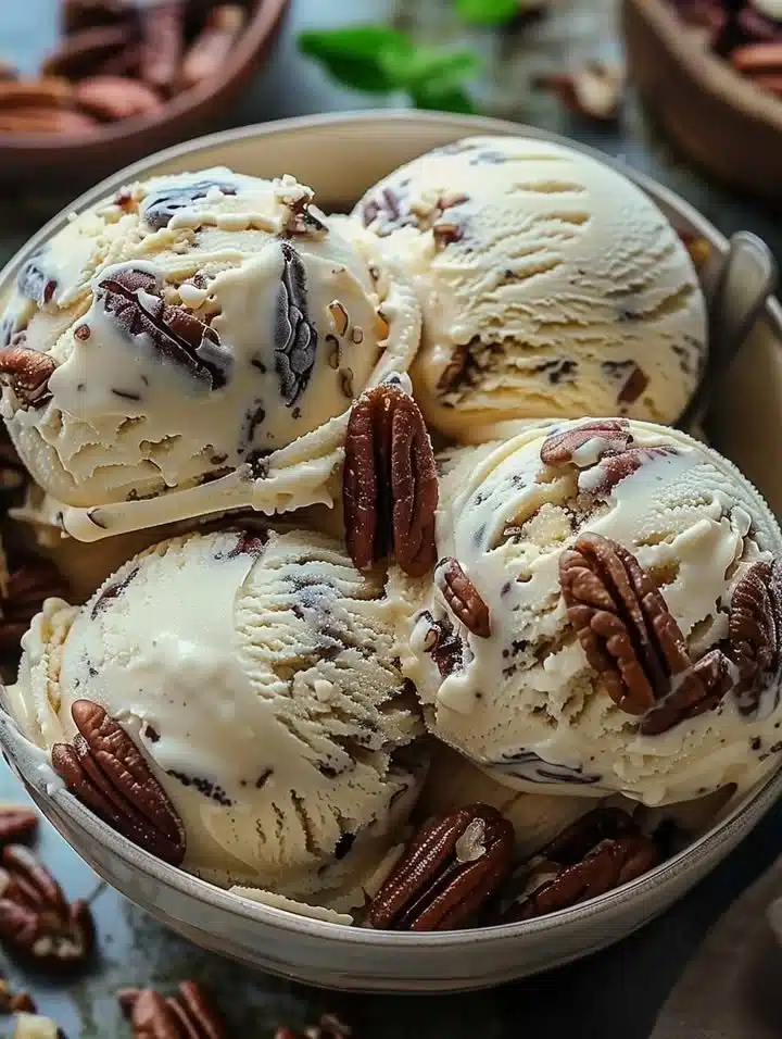 A bowl of homemade butter pecan ice cream with crunchy pecans