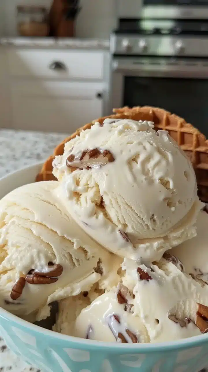 Homemade butter pecan ice cream with crunchy pecans in a bowl