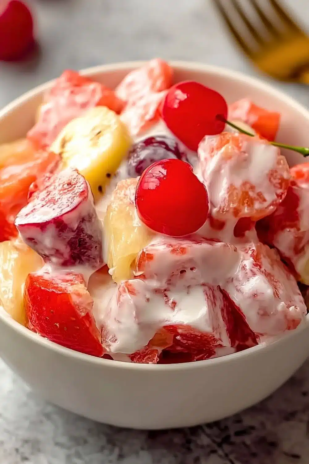 Colorful homemade fruit salad with various fresh fruits in a bowl