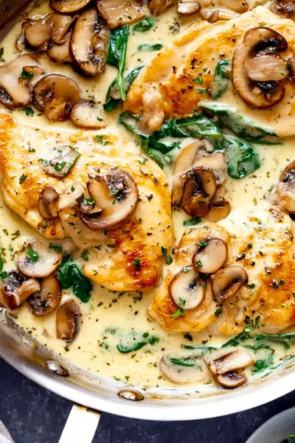 One-Pan Creamy Parmesan Garlic Mushroom Chicken dish garnished with herbs
