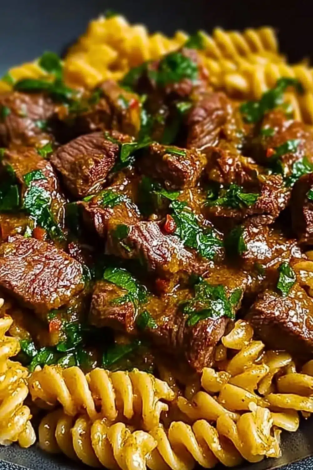 One Pot Creamy Spicy Garlic Butter Steak & Pasta dish with vibrant flavors