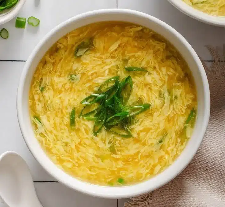 Bowl of delicious Chinese Egg Drop Soup with green onions garnish