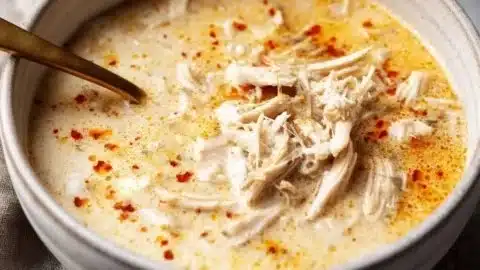 Bowl of high protein low carb white chicken chili topped with fresh cilantro