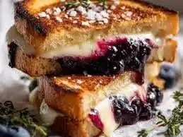 Juicy blueberry grilled cheese sandwich with melted cheese and fresh blueberries