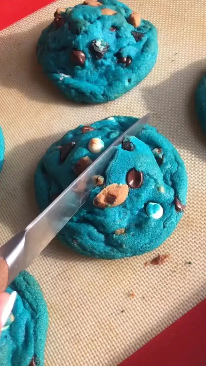 A batch of delicious monster cookies filled with chocolate chips and M&Ms.