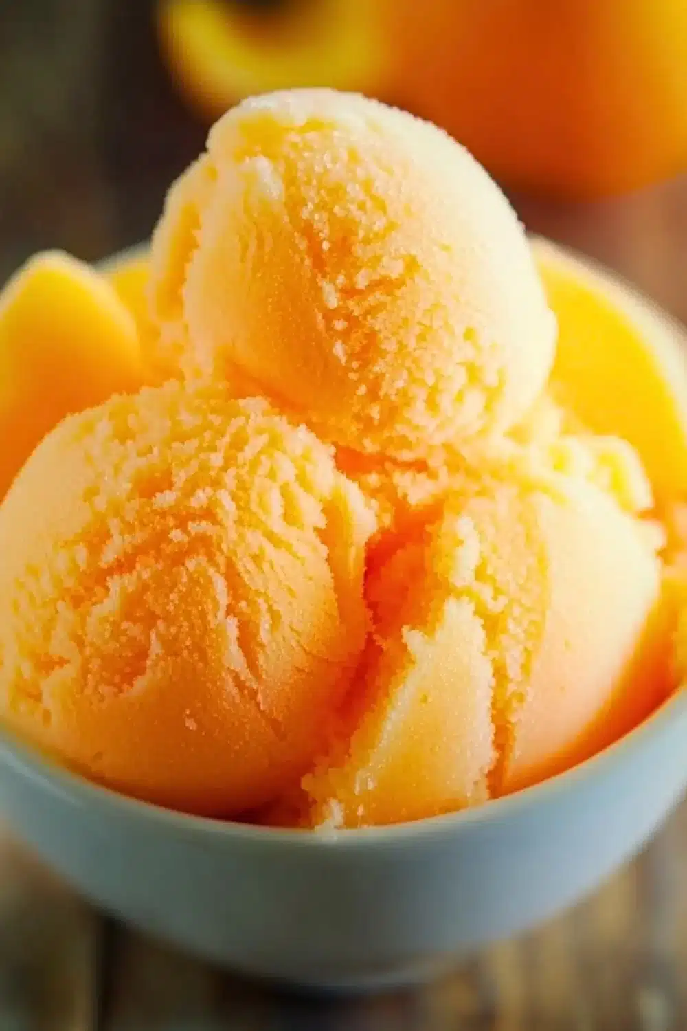 Refreshing bowl of homemade Orange Crush Sherbet served in a colorful dish.