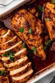 Juicy and flavorful oven baked chicken breast on a serving plate