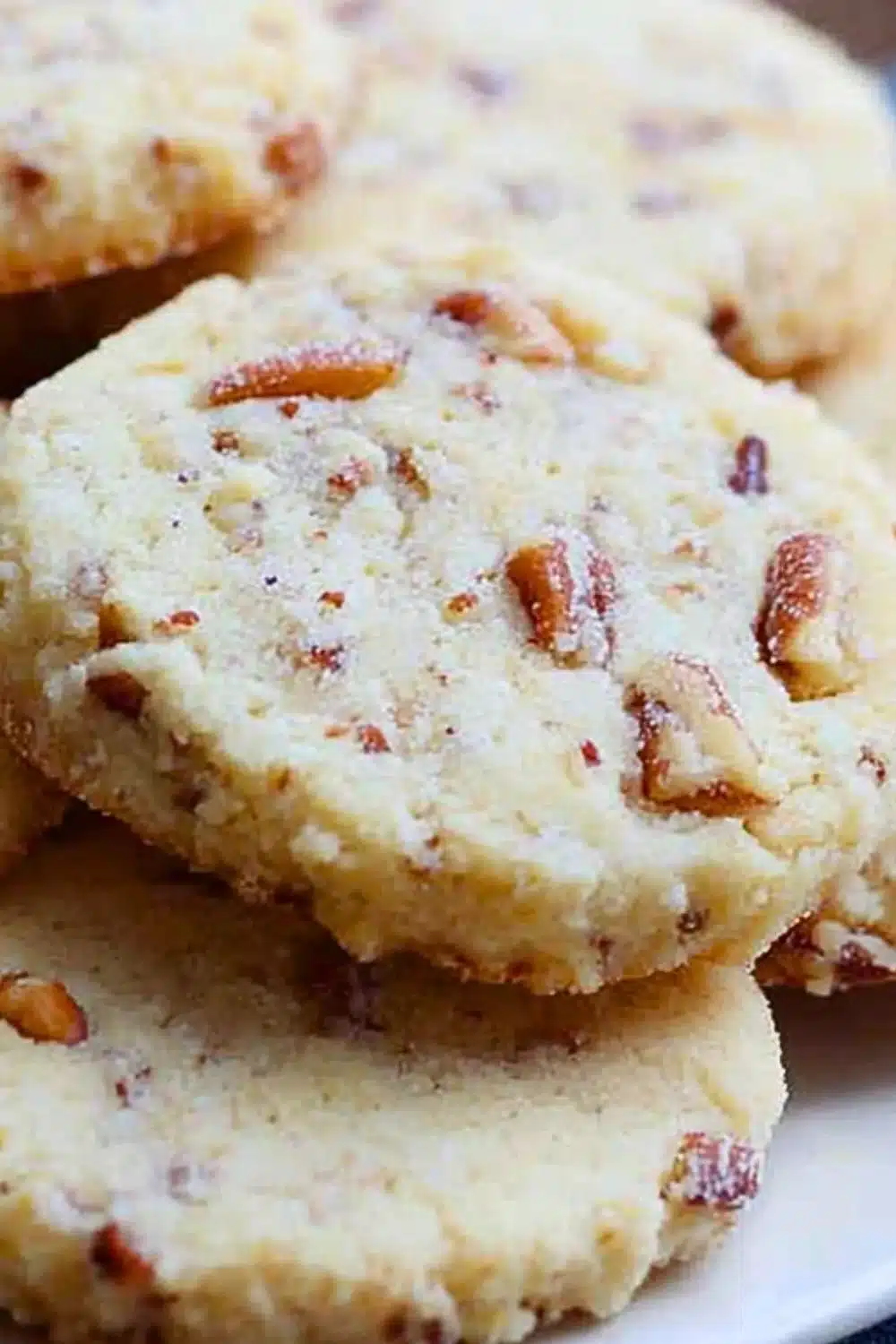 Delicious Pecan Sandies cookies with crunchy pecans on a plate