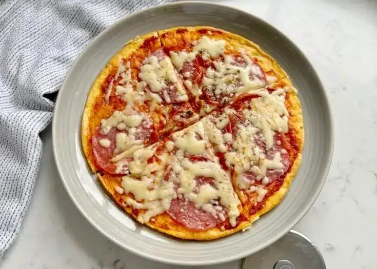 Dish of Pizza Eggs topped with herbs and cheese