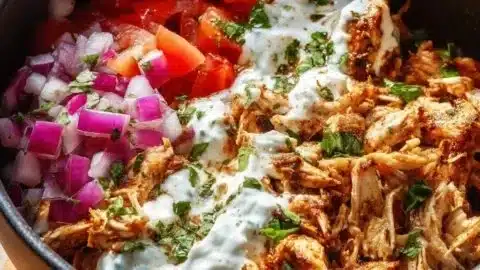 Delicious slow cooker chicken shawarma served with fresh vegetables.