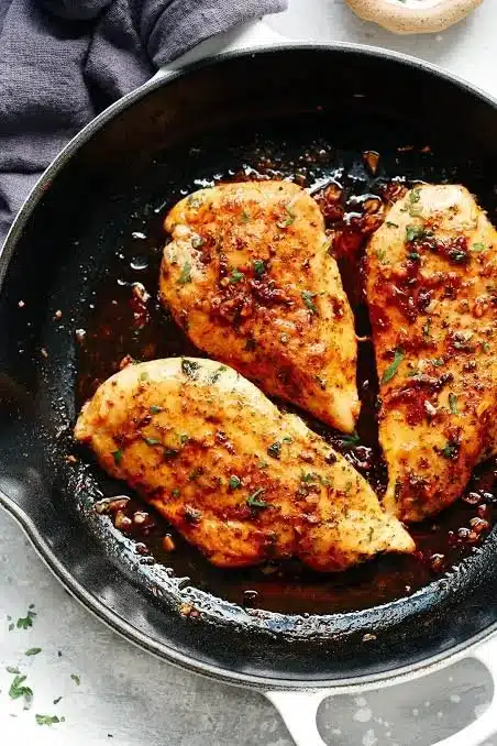Juicy baked chicken breast served with vegetables on a plate