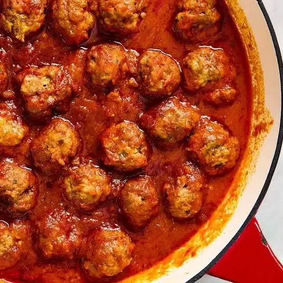 Delicious beef meatballs served with marinara sauce and parsley garnish.
