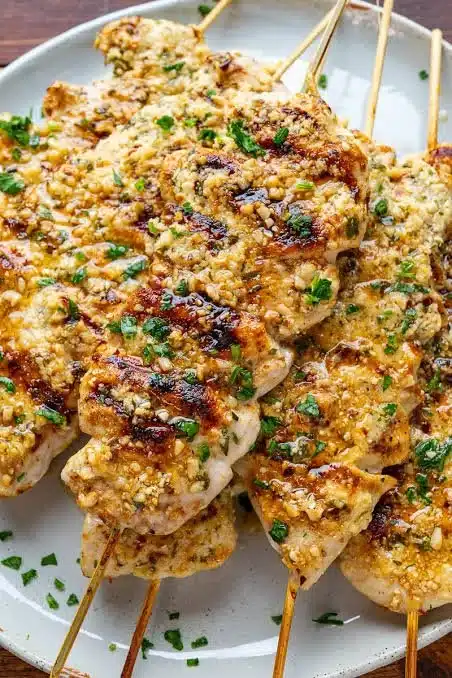 Juicy grilled chicken served on a plate with herbs and spices