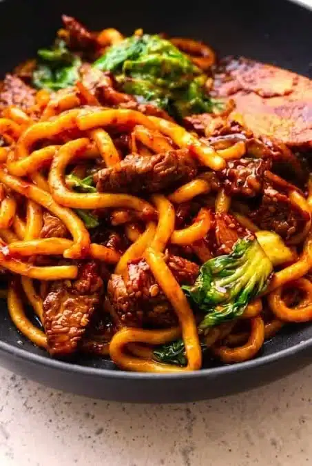 Delicious Beef Black Pepper Udon served in a bowl with fresh vegetables