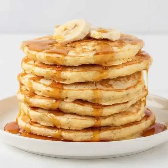 Delicious Banana Protein Pancakes stacked on a plate.