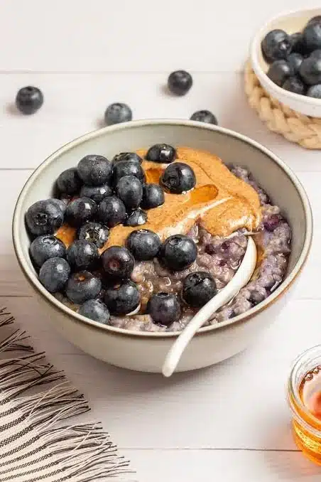 Blueberry Protein Overnight Oats topped with fresh blueberries and nuts.