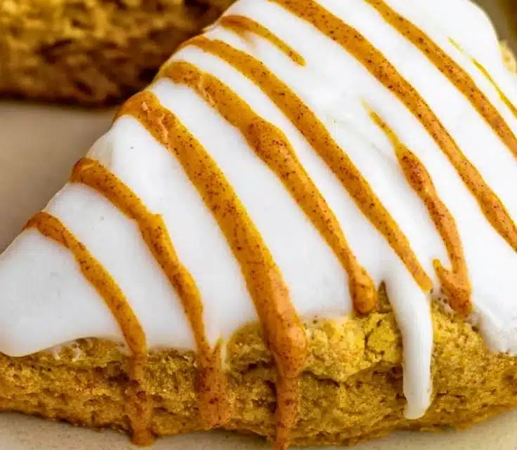 Delicious homemade easy pumpkin scones on a rustic wooden table.