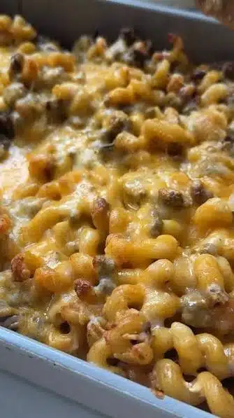 High Protein Cheeseburger Casserole topped with cheese and herbs