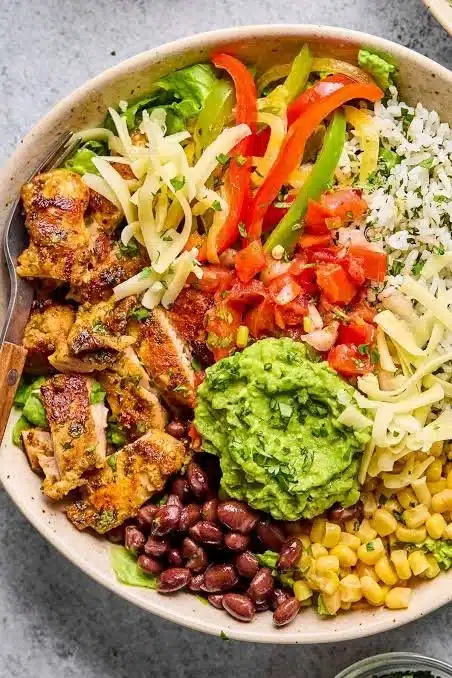 High protein chicken burrito bowl with fresh ingredients and colorful toppings