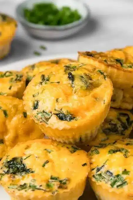 High protein egg breakfast muffins with vegetables and cheese in a muffin tray