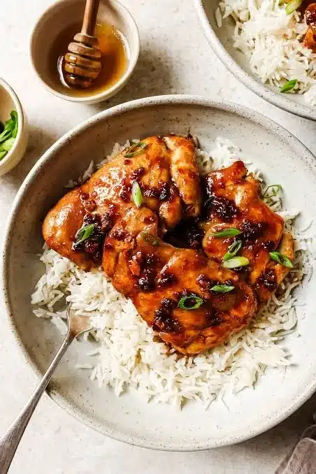 Delicious honey garlic chicken thighs garnished with green onions