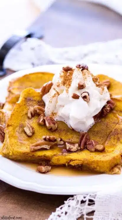 Delicious Pumpkin French Toast topped with syrup and whipped cream.