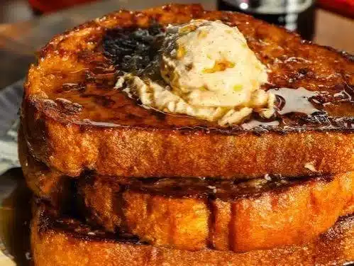 Delicious Pumpkin French Toast topped with syrup and spices on a plate.